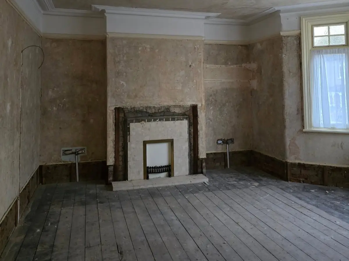 A Woodford Green front room stripped back to the old walls before plastering