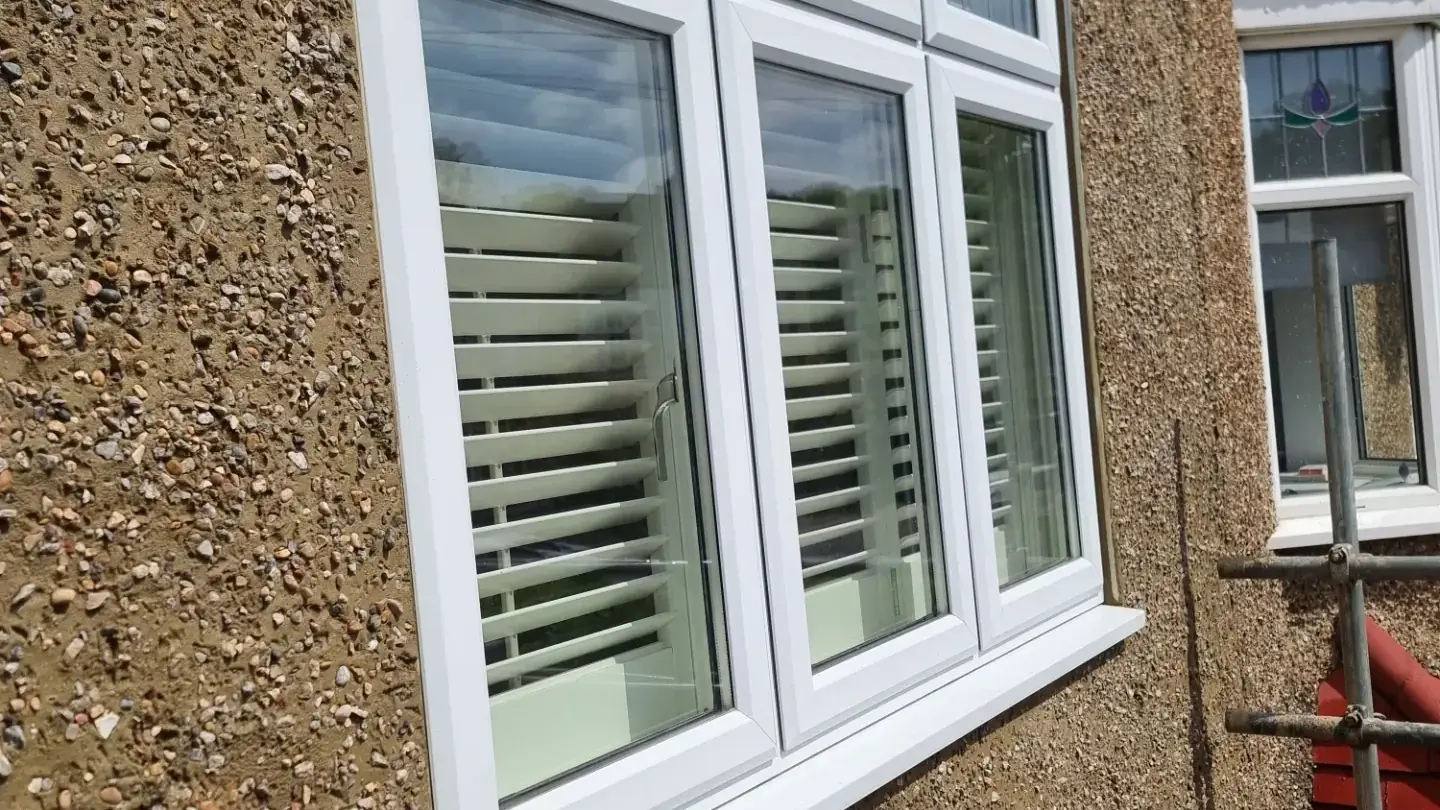 New pebbledash around bay windows with stained-glass tops, by ST Plastering & Rendering