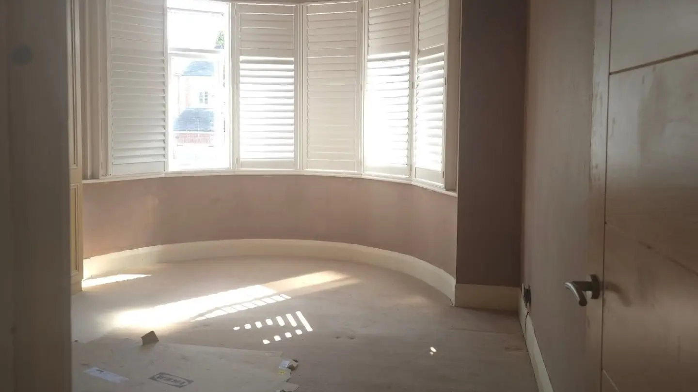 Bedroom with a curved bay window plastered in Upminster by ST Plastering & Rendering