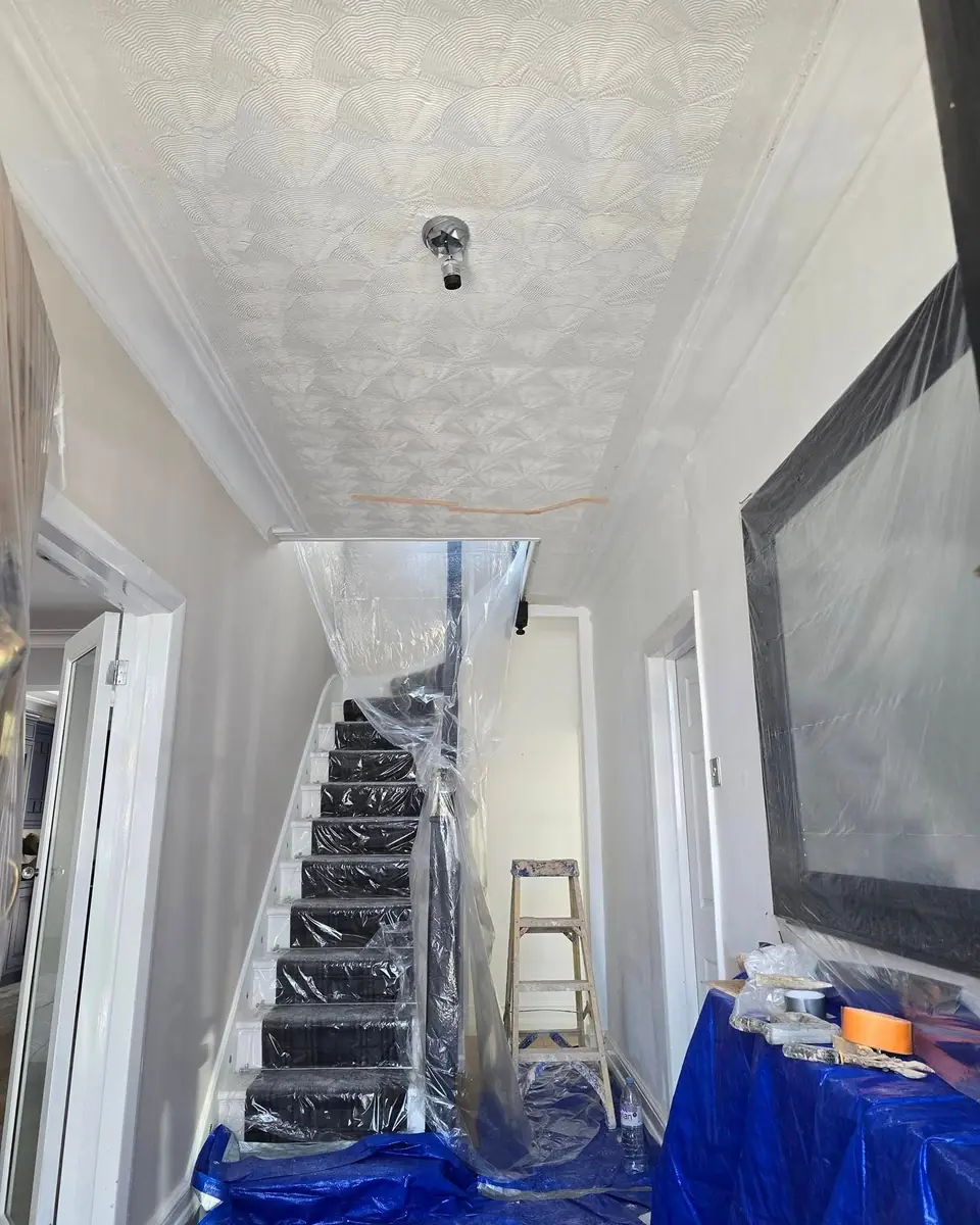 Patterned Artex hallway ceiling before skimming, stairs sheeted