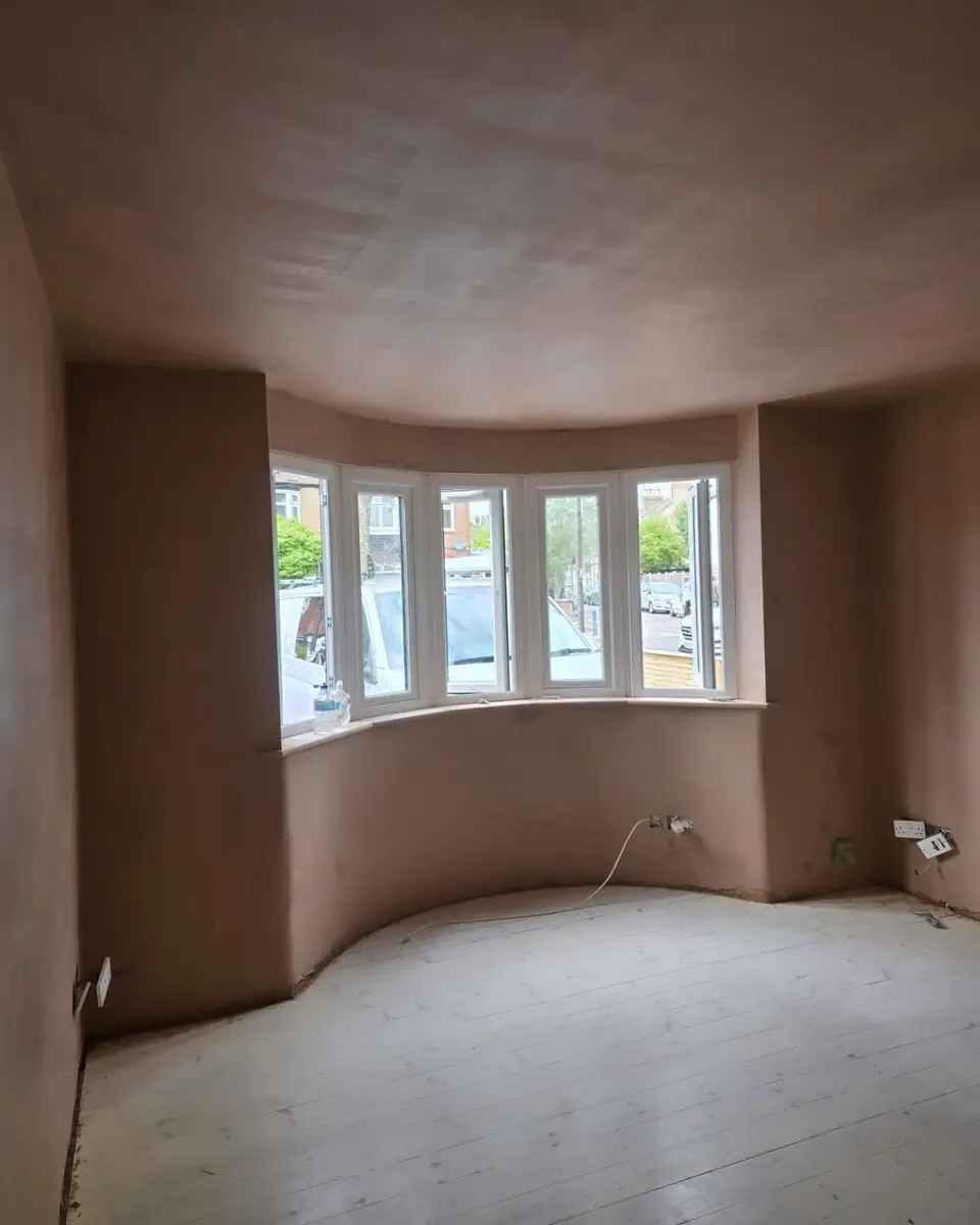 Curved five-light bay window room freshly plastered by ST Plastering & Rendering