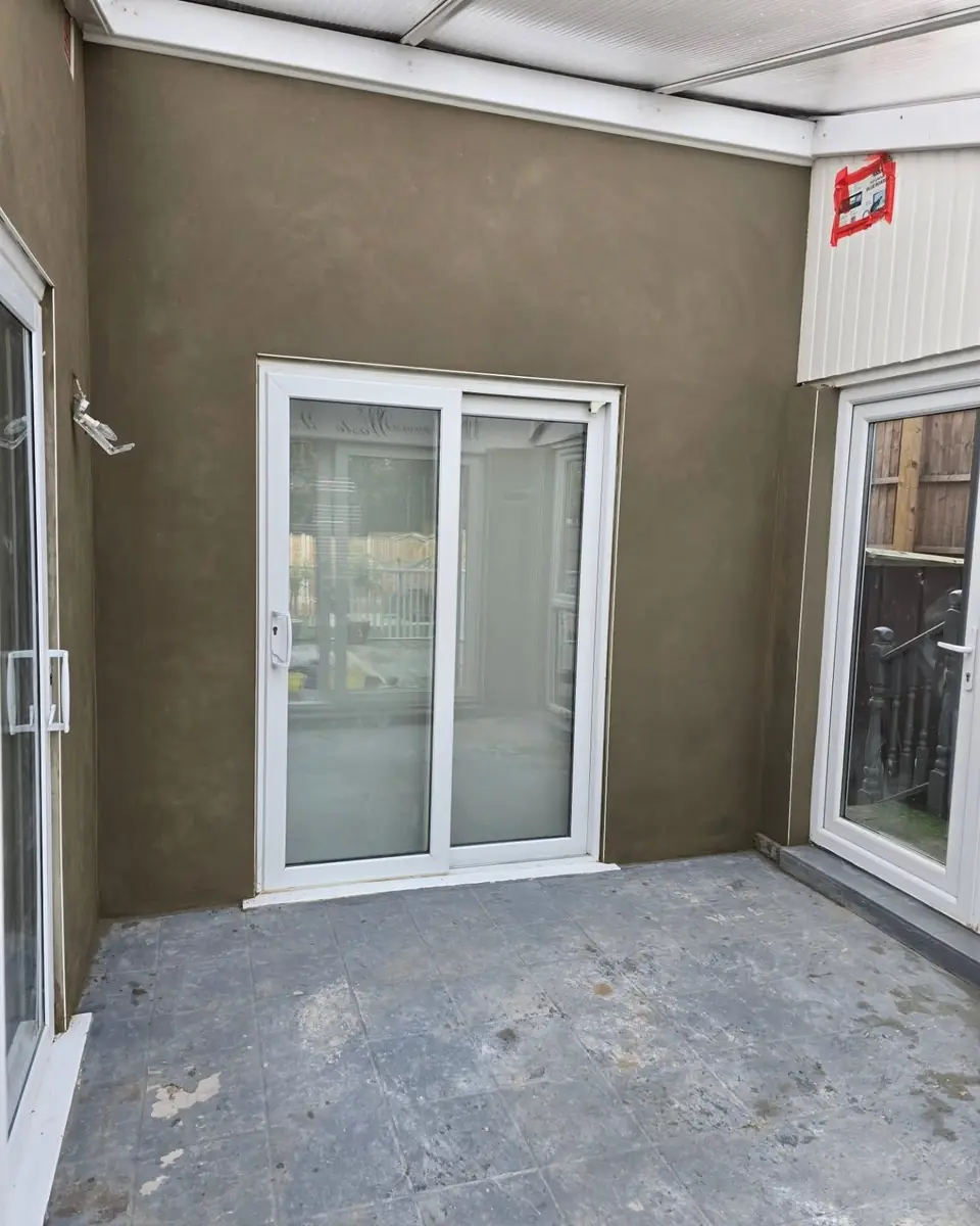The same Epping conservatory with its walls rendered smooth in sand and cement, by ST Plastering & Rendering