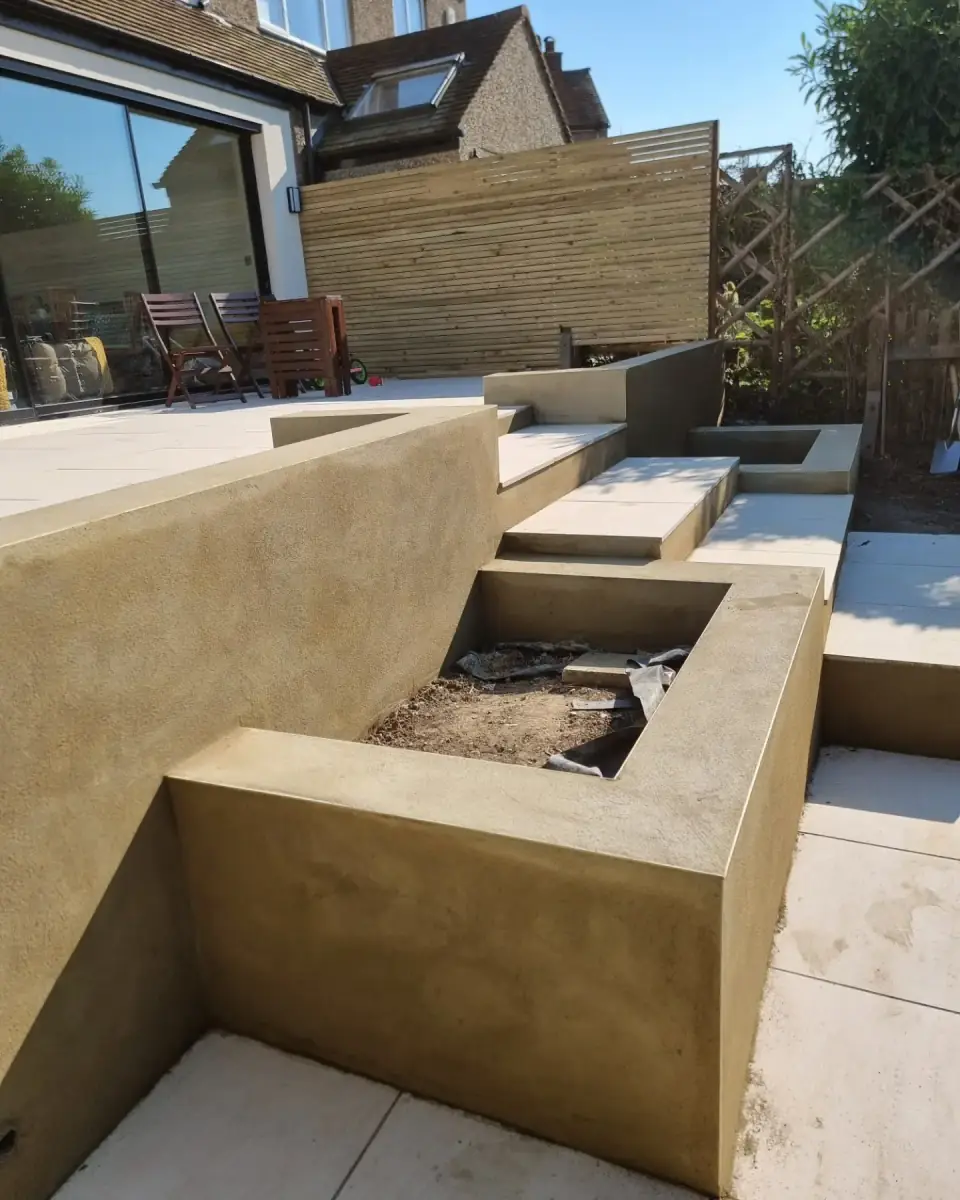 Rendered garden planters, retaining wall and steps on pale paving, by ST Plastering & Rendering